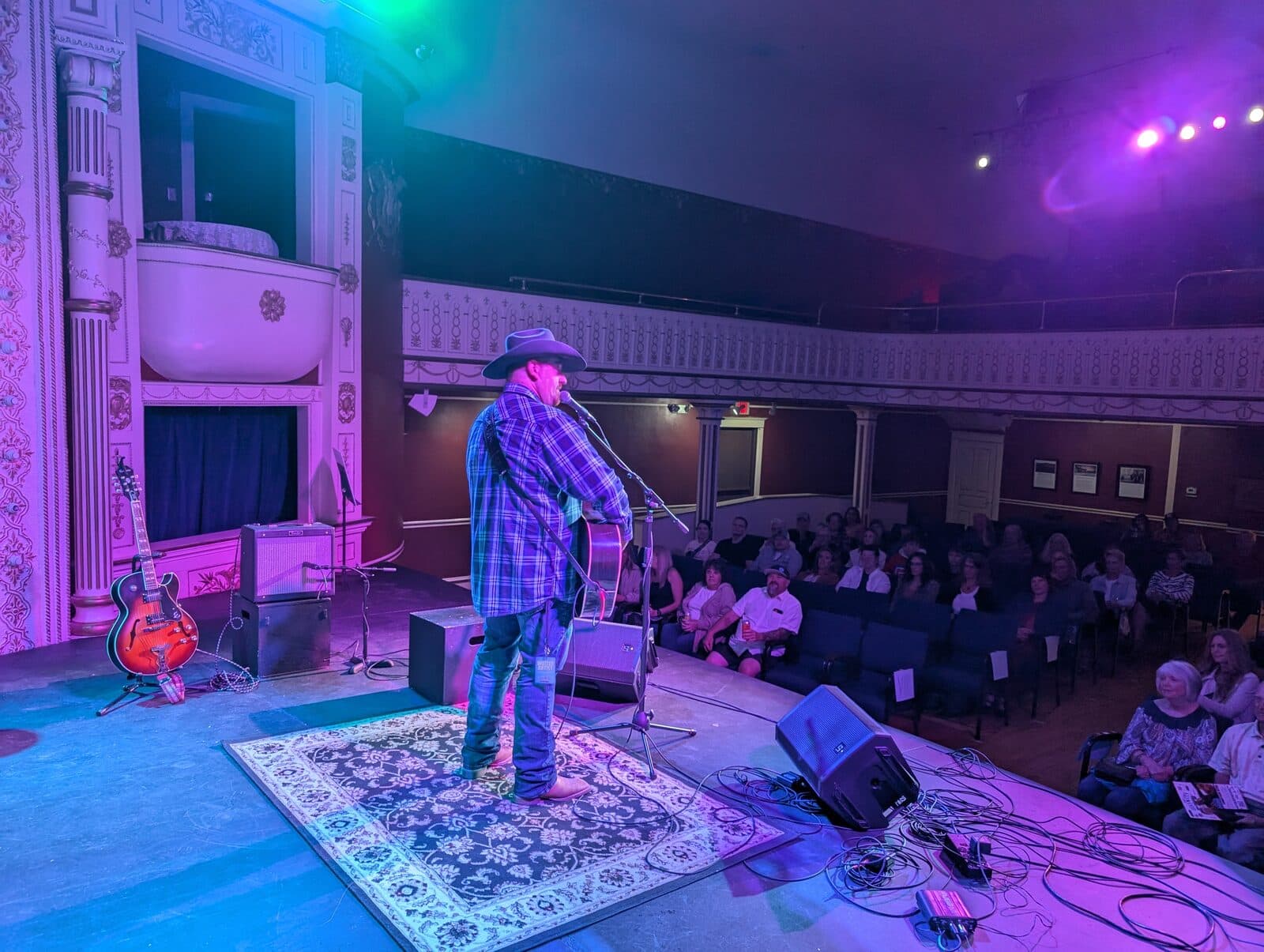 Jonathan Byrd performing on The Matthews stage with crowd visible, 2024 Invitational