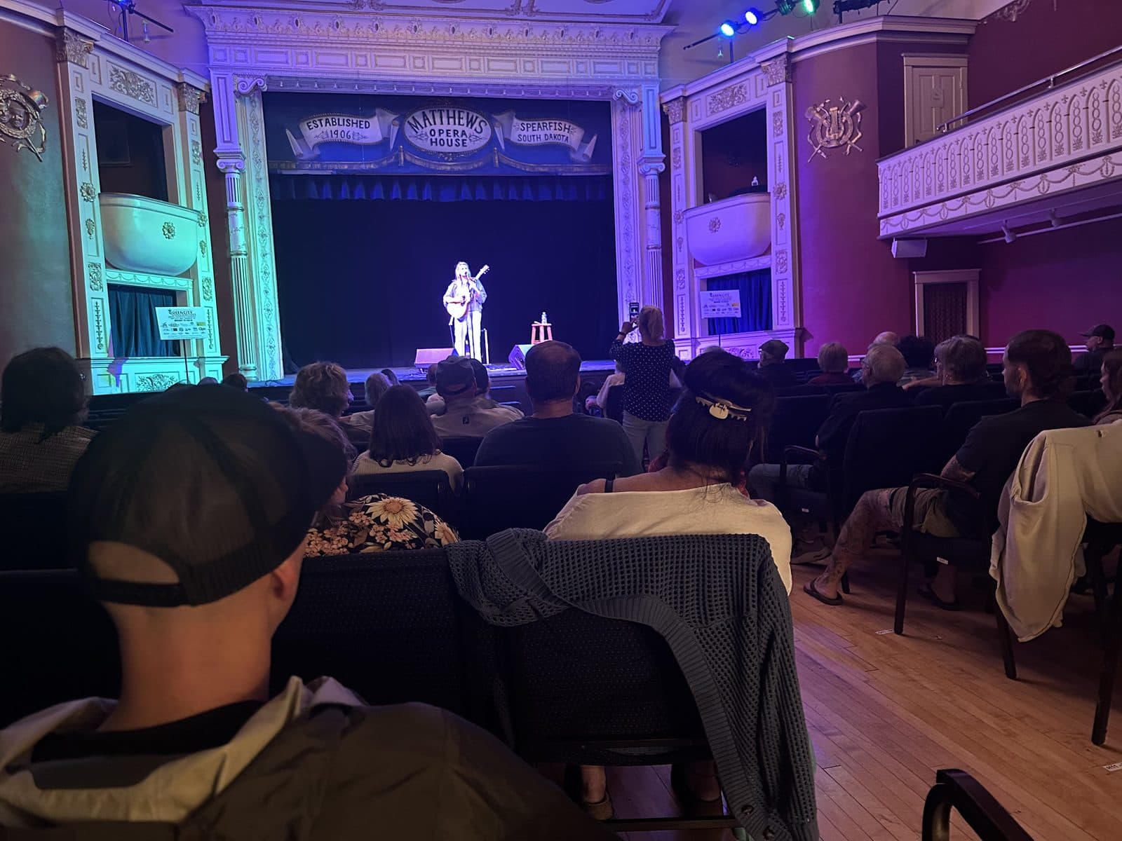 Artists sharing songs at a daytime round