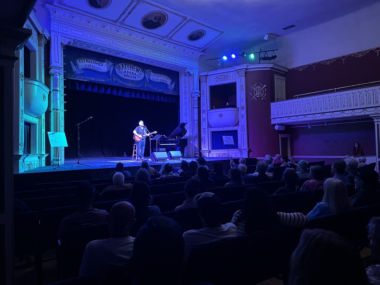 Songwriter on stage at The Matthews Opera House