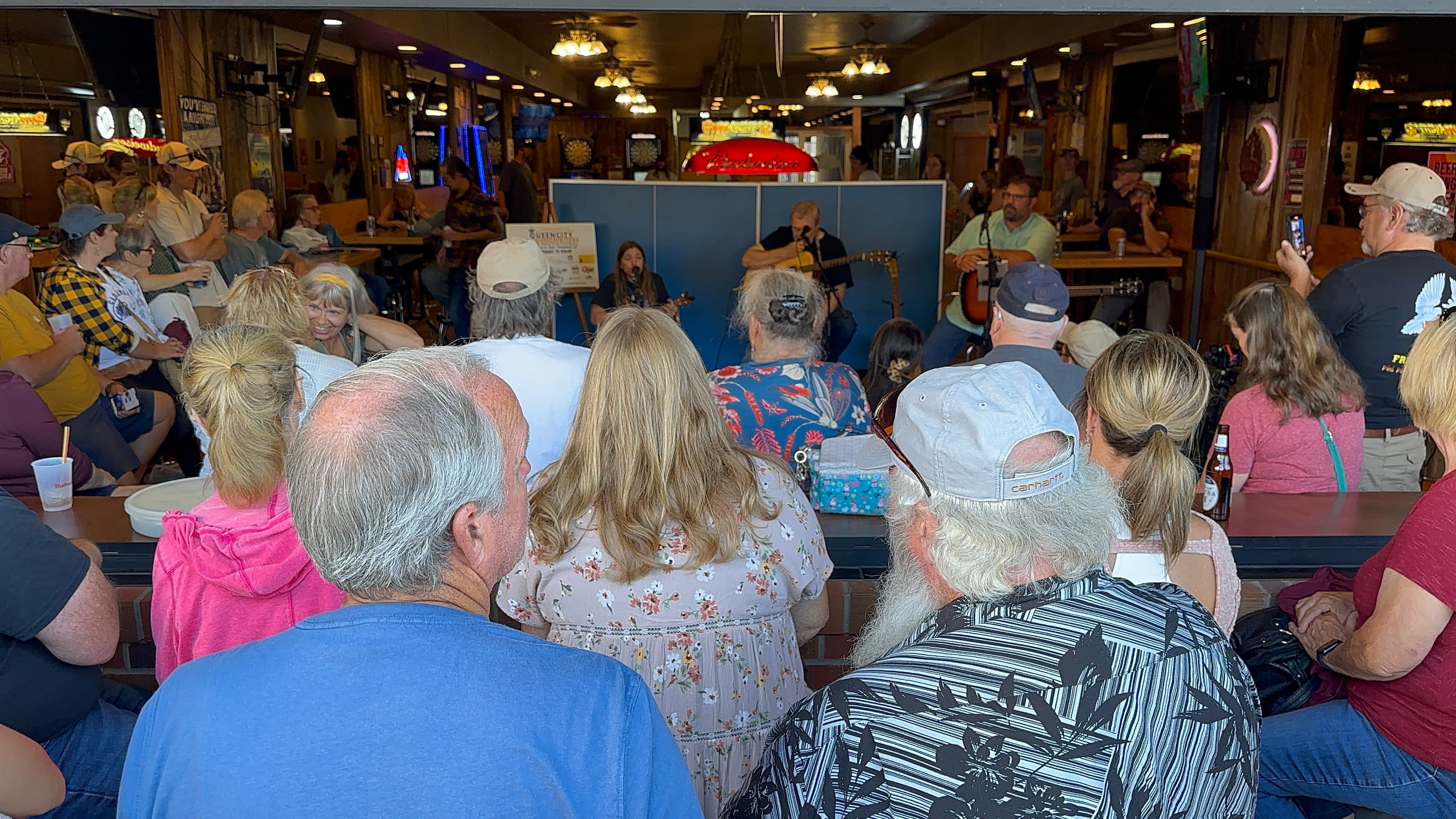 Packed crowd watching a songwriter round during the Queen City Songwriters Invitational