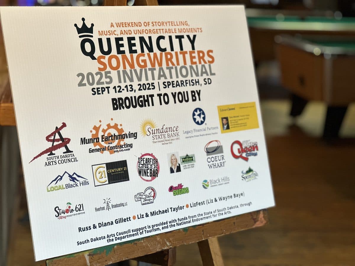 Sponsor board at the 2025 Queen City Songwriters Invitational