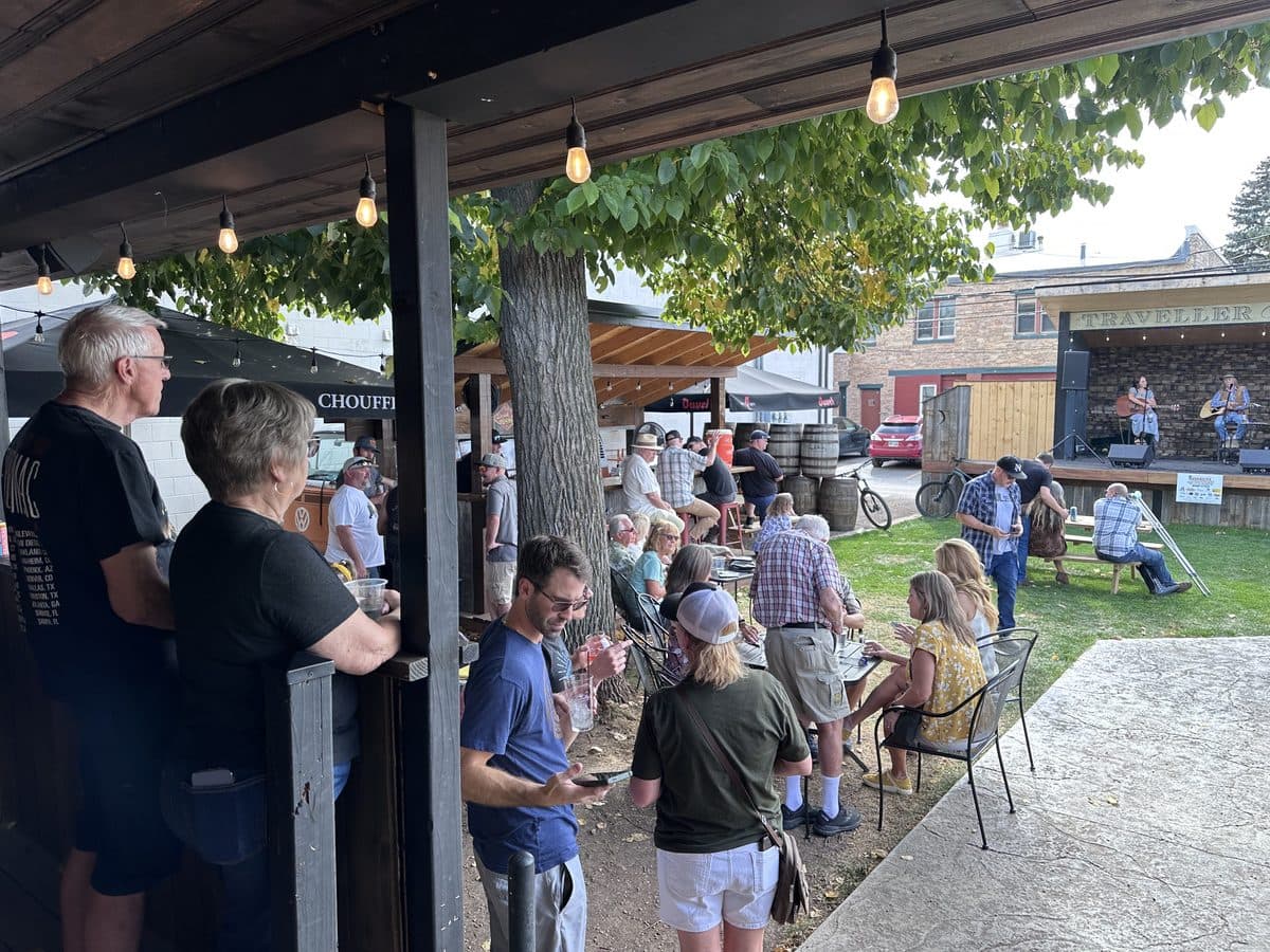 Community enjoying live music on a Spearfish patio during the Invitational